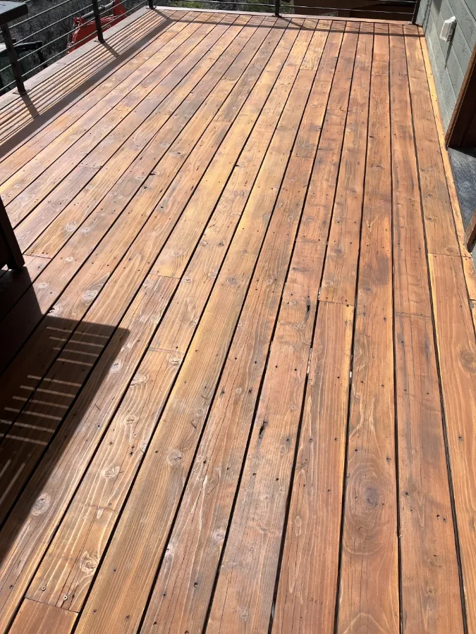 A deck that has been scraped, refinished and sealed.